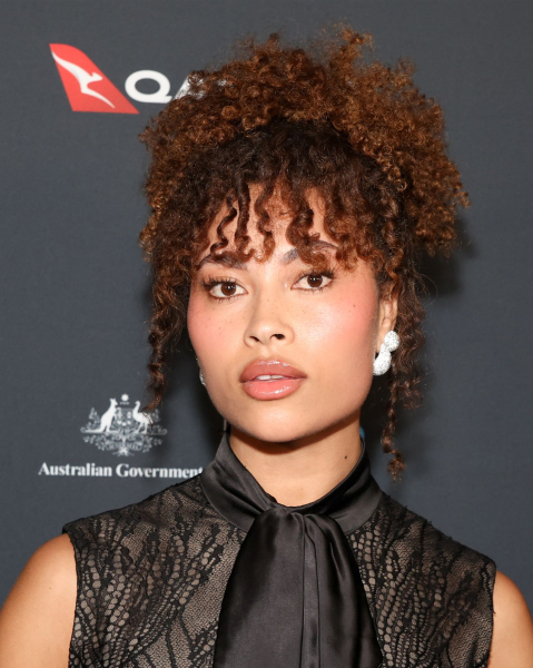 Closeup of a woman with the burnt sienna hair trend.
